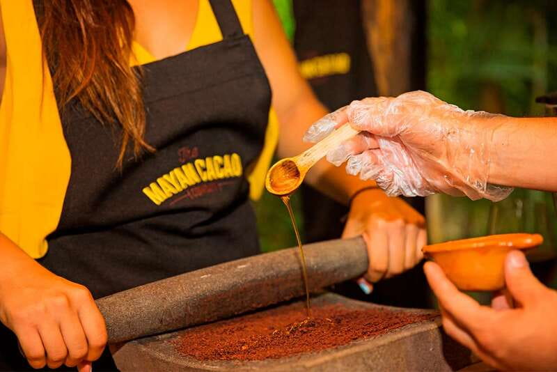 Cozumel: Chocolate Workshop at The Mayan Cacao Company - Grinding cacao on a pre-Hispanic metate