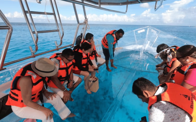 Explore the sea of cozumel in a transprent boat with drinks and snorkel. - Boarding, comfort, and who should skip it